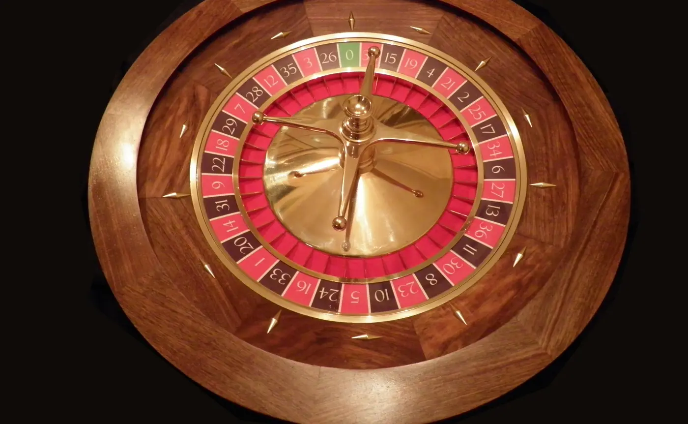 Roulette wheel on a dark casino table
